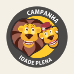 Logotipo circular da Campanha Idade Plena. Dois leões ilustrados, sorridentes, aparecem no centro. Ao redor, em fundo escuro, está o texto “Campanha Idade Plena”.